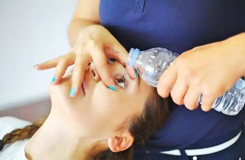 flush with running water to eyes